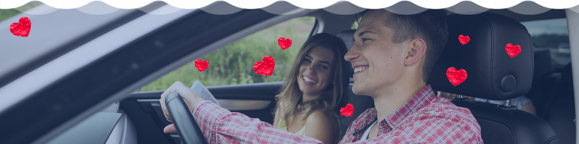 Man and woman smiling in car