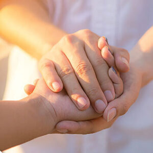 Two people resting hands in one another