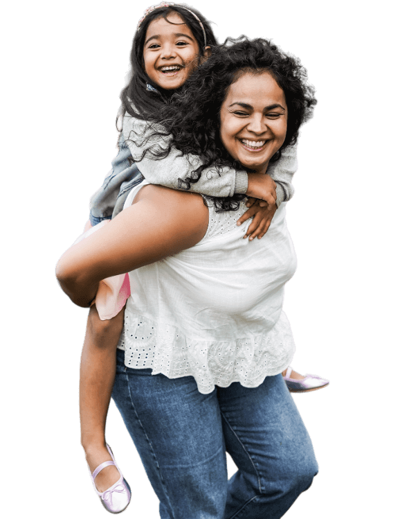 Mother with daughter riding on her back while both smile.