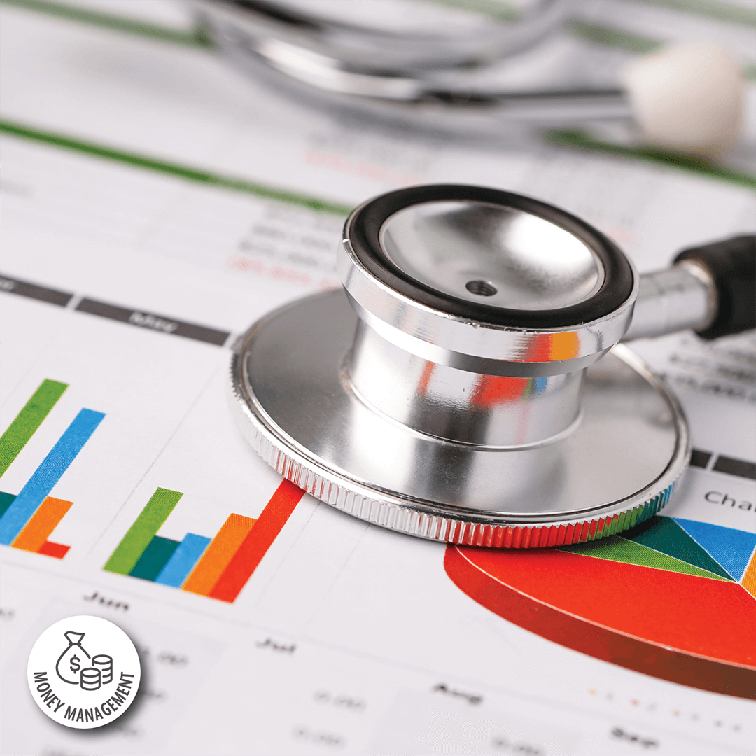 Stethoscope resting on top of documents with bar charts and pie charts print on them.