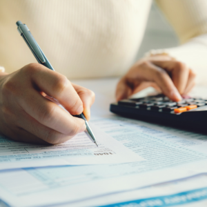 Woman writing and calculating her tax