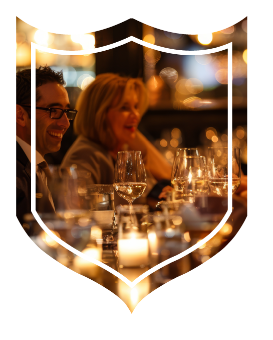 People sitting around table with drinks and candles lit