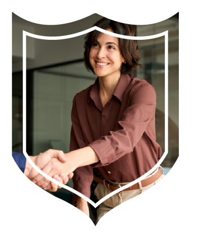 Woman shaking hands with another person in conference room.