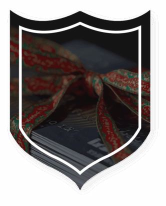 Credit card wrapped in holiday ribbon sitting on surface.