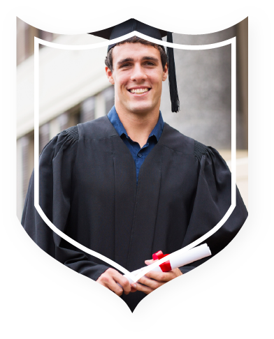 A young man in a graduation cap and gown smiles, holding a diploma. He stands outside a building, conveying pride and accomplishment.